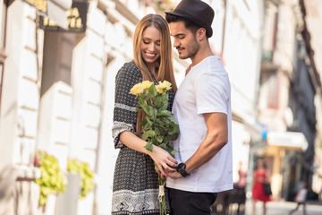 Beautiful couple with flowers dating.