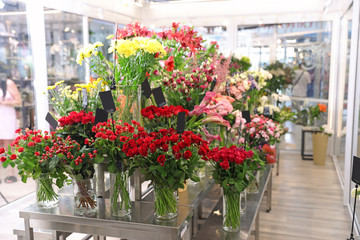 Fototapeta na wymiar Assortment of beautiful flowers in shop. Florist's workplace