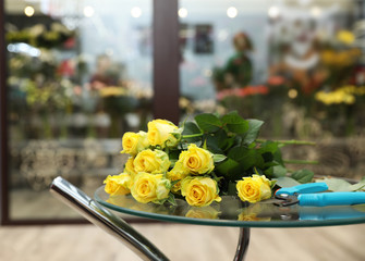 Beautiful bouquet on table in flower shop. Florist's workplace