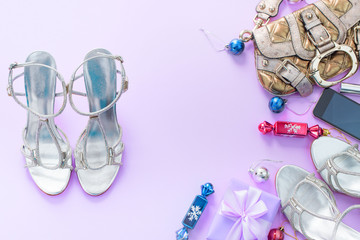 Christmas background pink Flat Lay fashion accessories handbag sandals phone gift box bow balls purple.