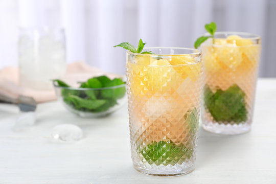 Tasty melon ball drink in glasses on table