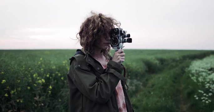 Millennial female using vintage 8mm film camera