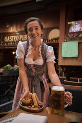 waitress in traditional clothes serving drink and food 