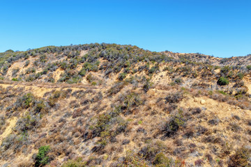 Fototapeta na wymiar Hiking and biking trail in middle of dry California mountain hillsides