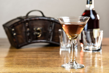 Whiskey or bourbon or mixed drink, neat, on a rustic, old, wood table