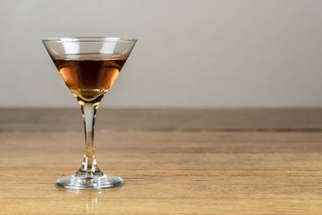 Whiskey or bourbon or mixed drink, neat, on a rustic, old, wood table