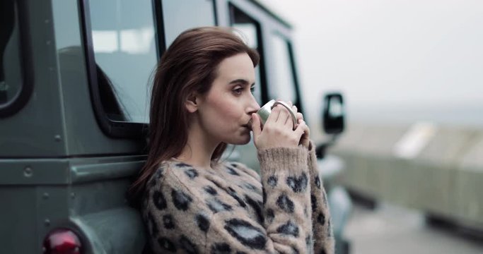 Millennial female taking a break on a road trip