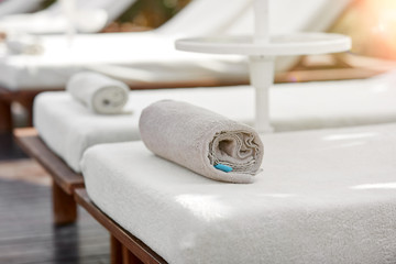 Sunbeds with towels near the pool zone