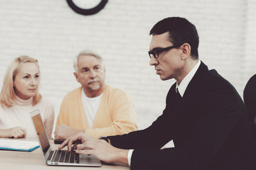 Old Man and Woman Visiting Young Lawyer in Office.