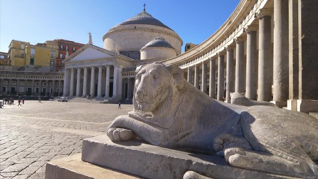 Stone lion statue in front of Piazza del Plebiscito in Naples, Italy