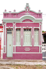 Old rose house with white doors, in paralelepipedo street, Andarai, Bahia, Brazil