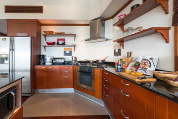 Fototapeta premium Luxury interior design pool villa in kitchen area which feature island counter and built in furniture