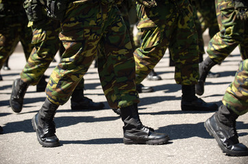 Military marching in a street. Legs and shoes in line