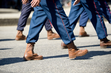 Fototapeta na wymiar Military marching in a street. Legs and shoes in line