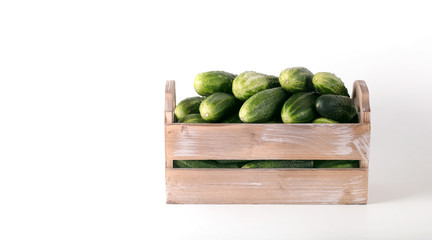 Cucumbers in a wooden box prepared for sale. 