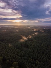 Fototapeta na wymiar Beautfiful summer sunset over foggy european forest