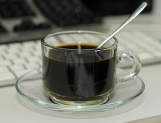 Coffee cup on desk A keyboard background