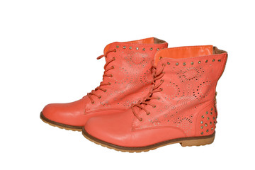 Women's genuine leather ankle boots with metal rivets on insulated background 