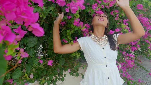 Beautiful woman on the flowers wall background