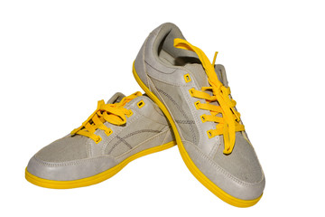 Grey sneakers with yellow laces on isolate. 