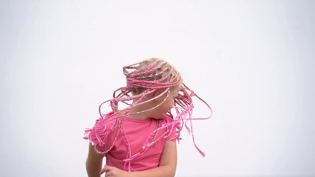 the beauty of slow motion - portrait of a beautiful light-skinned little girl of a non-standard modern appearance - with pink African plaits of zizi
