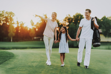 Happy Young Family Relax on Golf Field in Summer.