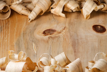 Wood shavings over a wooden surface background
