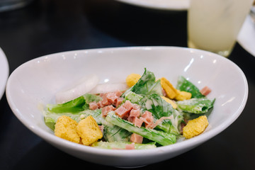 vegetables salad with ham and bread on top