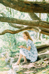 beautiful girl in the Park, in a summer dress and walking. Smiles and enjoys nature. St. Petersburg, Yelagin island
