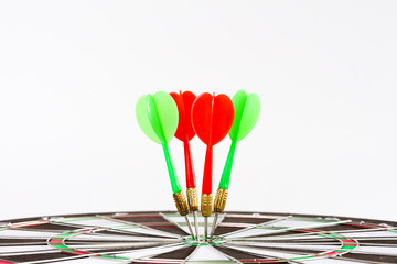 Close up shot green and red darts arrows in the target center. Business target or goal success and...