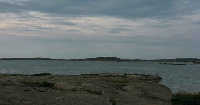 People relaxing on cliffs and bathing on an island in the swedish archipelago