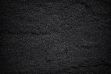 Dark grey black slate background or natural stone texture.