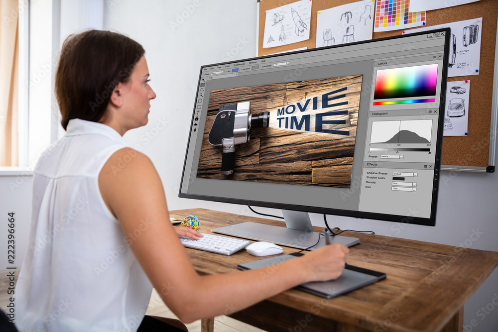 Poster designer editing image in computer