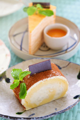 Roll cake with powder  of chocolate ,One piece in plate