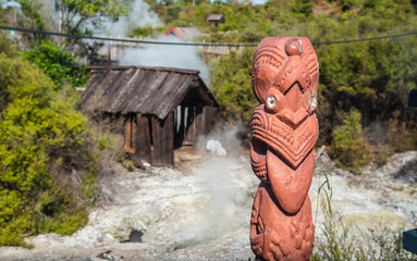 The Maori art carving decoration at natural hot springs in Whakarewarewa the living Maori village in geothermal area of Rotorua, New Zealand.