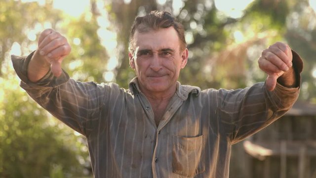 Middle aged farmer dissatisfied, frustrated - Shaking head, negative sign, not accepted - disliked, disappointed - unhappy