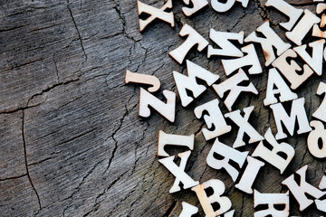 Wooden letters on a background of wood texture of an old stump. Copy space. High detail.