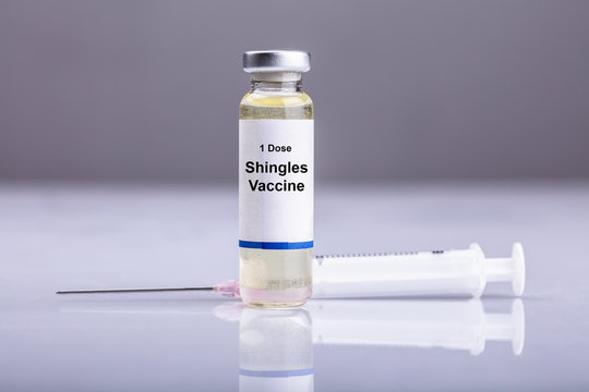 Close-up Of Shingles Vaccine And Syringe