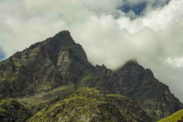 green mountains and peak in clouds