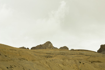 yellow sandy mountain hills with rocks