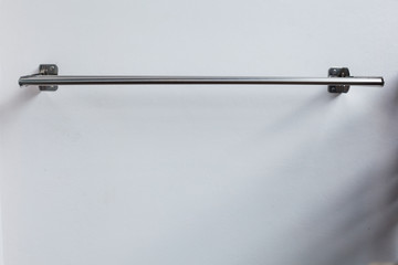 Outdoor Wall Mount Clothes Drying Rack Hanger on white wall background. House furniture, home...