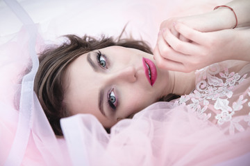 Portrait of an attractive brunette in a pink dress
