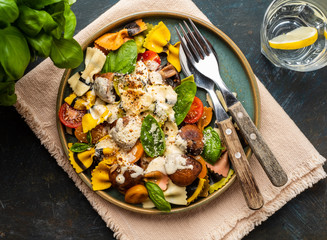 Pasta Farfalle with mushrooms, basil, tomatoes and cream sauce. Italian traditional cuisine. Mediterranean food