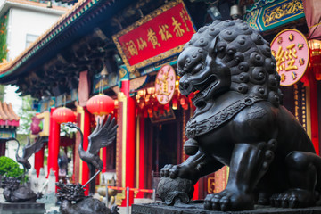 close up Lion Guardian bronze sculpture at the Sik Sik Yuen Wong Tai Sin Temple in Kowloon, Hong Kong.