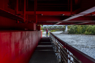 Red metal rungs under the bridge