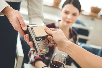 Non cash transaction. Selective focus of a credit card being pressed to a money terminal