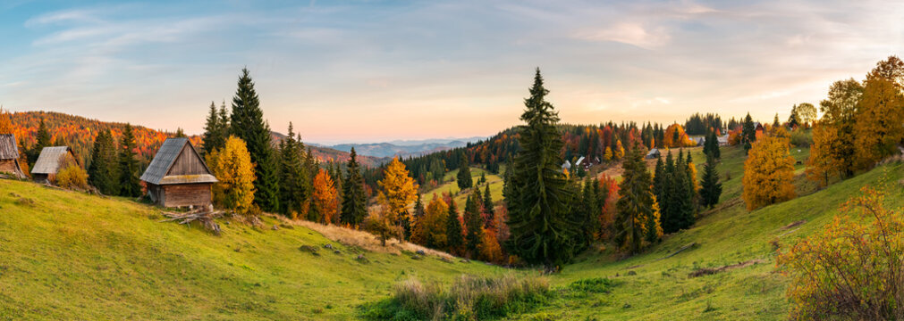panorama of village in Apuseni mountains. beautiful autumn landscape at sunset. mixed forest in red foliage. wonderful rural countryside of Romania