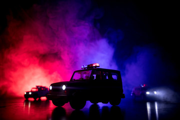 Police car chasing a car at night with fog background. 911 Emergency response police car speeding to scene of crime. Selective focus © zef art