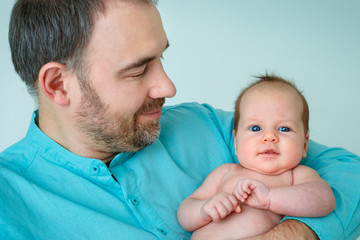 Cute newborn baby girl and her happy father