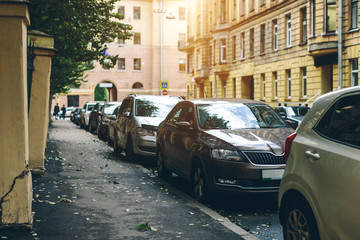 parked used cars stand on street parking during the day